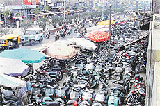 A scene at the Gill Road in Ludhiana, where scooter dealers have encroached upon public land