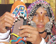An artisan of Kutch displaying her oeuvre.
