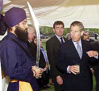 Britain's Prince Charles receives a salute after opening an exhibition