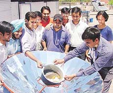 Students of PEC demonstrate a solar energy apparatus used to boil eggs during Sun Day celebrations in Panjab University on Friday.