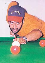 Deepinder Singh pots with ball on the opening day of the third Saurav Khattar Snooker Tournament played at the Chandigarh Club, Chandigarh, on Friday.