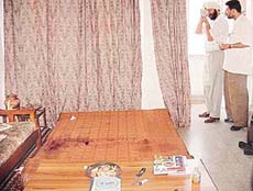 Finger print experts examine circumstantial evidence around the blood-soaked bed in a Phase 2 house where a 20-year-old girl was brutally stabbed by her father.