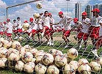 Hong Kong kids practise kicking balls 