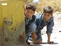 Two Palestinian boys hold stones 