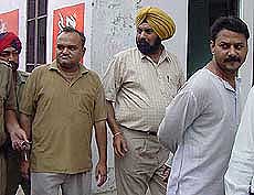 Vinodi Lal  and Vijay Gupta  being produced in a district court