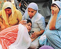 Grieving sister of Varinder Kaur being consoled by her relatives