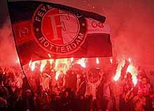 Feyenoord soccer fans wave a giant flag