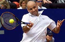 Andre Agassi of the U.S. returns the ball