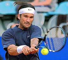 Spain's Carlos Moya returns a ball