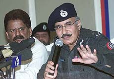 Syed Kamal Shah, Police Inspector General of the Sind Province gestures during his news conference