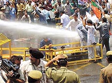Police use water cannons to disperse the BJP workers