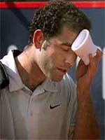 US player Pete Sampras wipes his face as he leaves the court