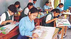 Schoolchildren concentrate on their posters during an inter-school painting competition 
