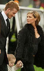 England soccer captain David Beckham (L), his wife Victoria and son Brooklyn walk through Luton airport before boarding a plane to Dubai on Monday. 