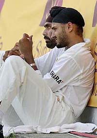 Indian spin bowlers Sarandeep Singh, left, and Harbhajan Singh, right, sit along the boundary 
