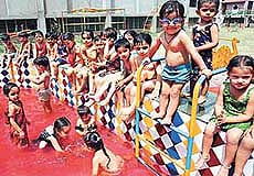 Tiny tots of St. Joseph School, Sector-44, enjoying a splash in a pool on the school premises in Chandigarh on Thursday.