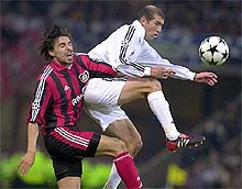 Real Madrid's Zinedine Zidane, right, is challenged by Bayer Levekusen's Zoltan Sebescen