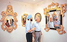Creator of Rock Garden Nek Chand inaugurates an exhibition of antique mirror frames at Art Folio, in Chandigarh, on Friday.