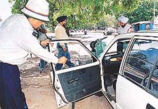 Traffic cops remove black films from vehicles during a special drive conducted in Chandigarh on Friday.