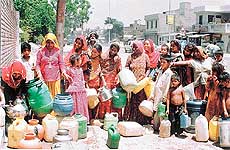Persons who live in the Pakhowal road area queue