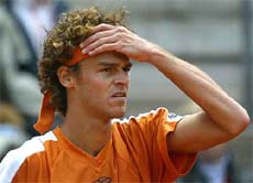 Brazilian player Gustavo Kuerten holds his head in disbelief