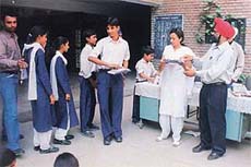 Stationery items being given to poor students at a function