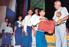Mr Ashwini Luthra, Commissioner, Income Tax, Chandigarh, distributes aid material among the needy and deserving students at a function in Chandigarh on Sunday.
