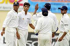 India's bowler Ashish Nehra, second from left, is congratulated