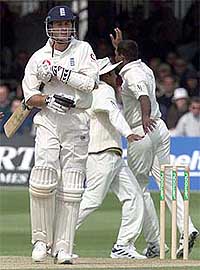 England's opening batsman Michael Vaughan walks back to the pavilion