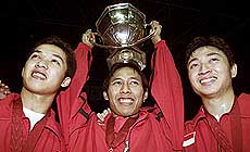 Indonesia's Taufik Hidayat , Sigit Budiarto and Halim Haryanto celebrate