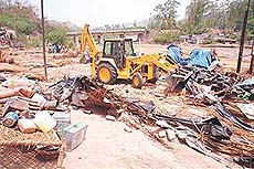 HUDA enforcement staff demolish jhuggis near Nada Sahib in Panchkula on Monday.