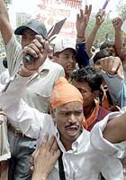A Hindu activist from the hardline Hindu group Bajrang Dal brandishes a small trident during an anti-Pakistan demonstration