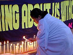 A woman lights candles