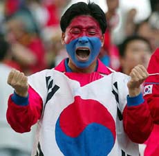 A South Korea fan shouts during the international friendly game