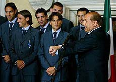 Italy's Prime Minister Silvio Berlusoni cuffs his hands