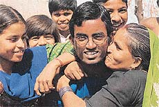 Rajesh Maurya, who topped the Class XII ICSE examination (non-medical) being hugged by his family in Rajiv Colony of Panchkula on Wednesday.