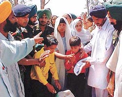 Son of Lance Naik Balbir Singh looks at the body of his father
