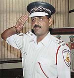 A traffic cop dons the new uniform for the Delhi Traffic Police personnel 