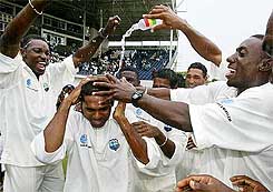 West Indies' players douse "Player of the Series" Shivnarine Chanderpaul