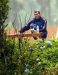 France's Zinedine Zidane stretches during his first training session