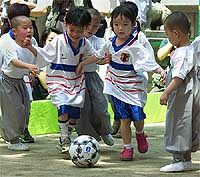 South Korean children, who are living the life of Buddhist monks for one month, and children from Japan play against each other