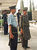A Pakistani policeman and a paramilitary soldier stand guard outside the British High Commission