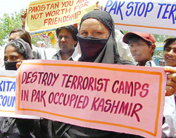 Muslim women hold an anti-Pakistan placards