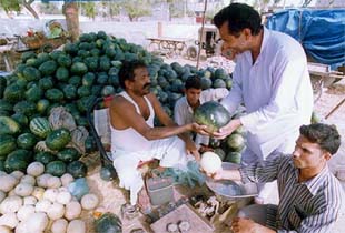 A watermelon seller is all smiles