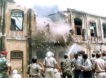 Fire fighters try to put out a fire at a shoe factory in Agra