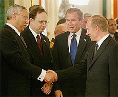 US Secretary of State Colin Powell shakes hands with Russian President Vladimir Putin