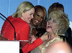 American actress Sharon Stone, Dame Elizabeth Taylor and Ethiopian model Iman joke together 