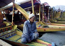 A Kashmiri 'shikarawala' waits for customers on the banks of Srinagar's famous Dal Lake in Jammu and Kashmir