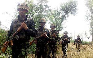 Army personnel patrol near the Indo-Pak border