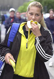 Russia's Anna Kournikova eats a banana before a training session at Roland Garros stadium in Paris on Friday. The French Open starts on Monday.